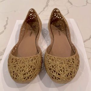Mini Melissa - sparkly gold slip on shoes.